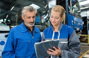 bus maintenance mechanic reading the clipboard